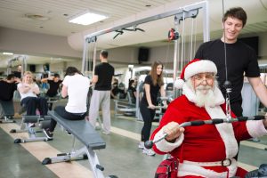 Santa Claus doing exercises at a gym