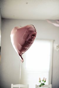 Pink heart balloon floating in the air